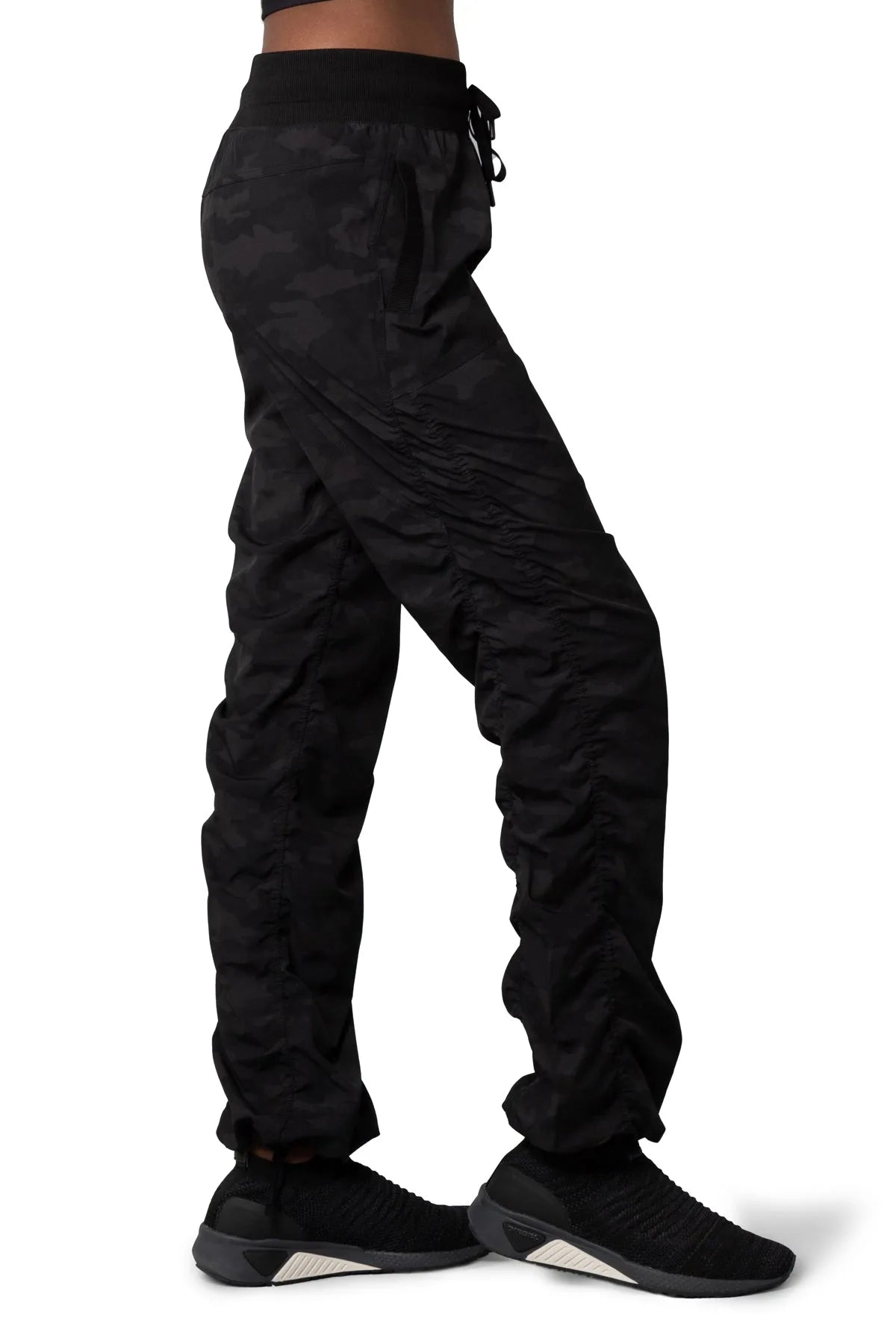 Women’s Dark camouflage print Adventurous Pant, side profile showing the elastic waistband, patch pocket and gathered hem.