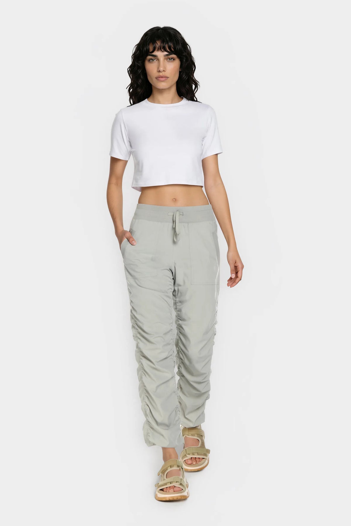 Women’s Cement Adventurous Pant, full-body studio pose showing the tapered leg, drawstring waist and gathered cuffs.