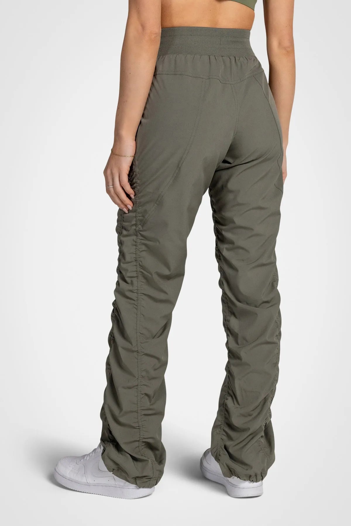 Women’s Dusty Olive Adventurous Pant, waist and pocket close-up showing the elastic drawstring waistband and utility pocket.