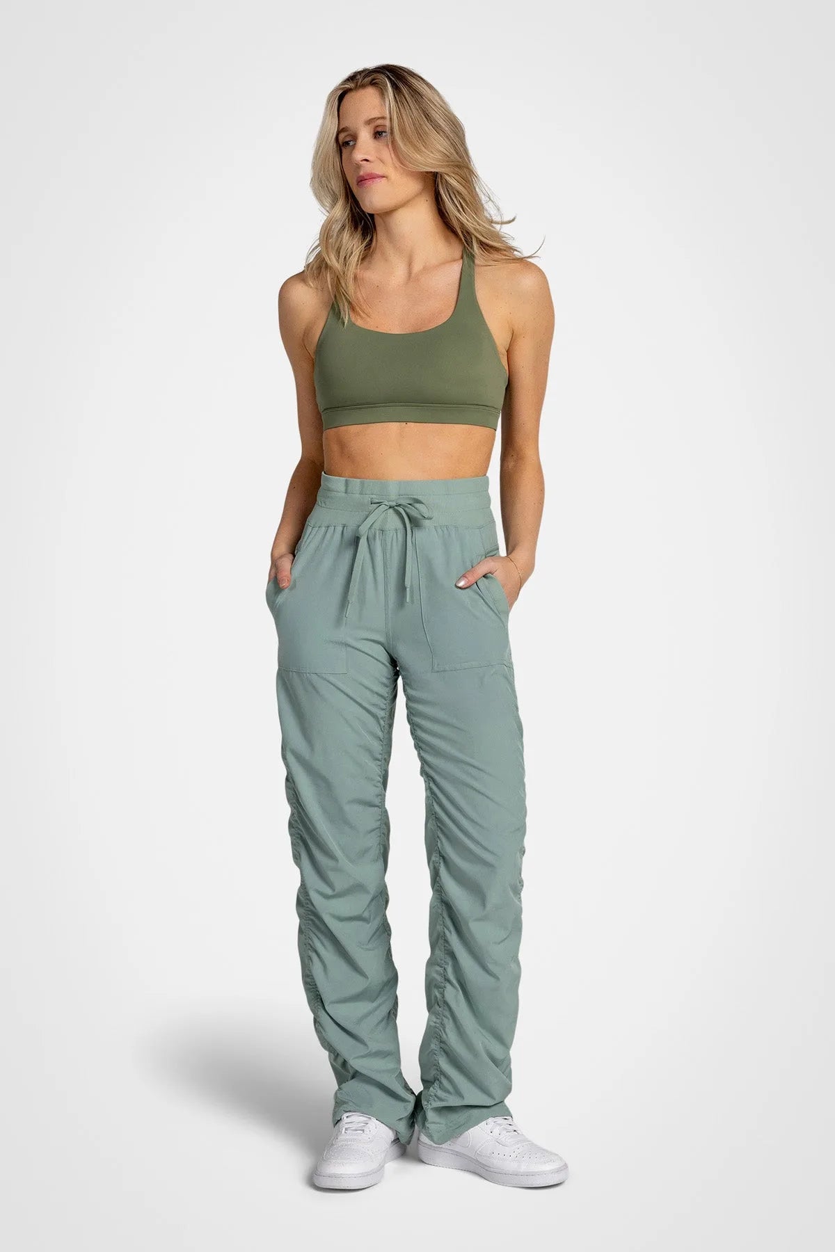 Women’s Iceberg Green Adventurous Pant, side studio view showing the relaxed tapered leg, utility pocket and gathered cuff.