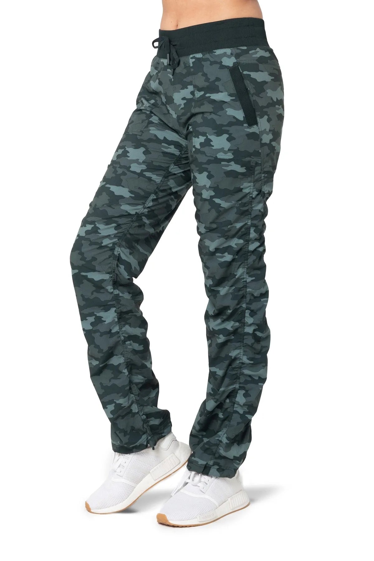 Women’s Black and green camouflage print Adventurous Pant, three-quarter studio view showing the relaxed tapered leg and side patch pocket.