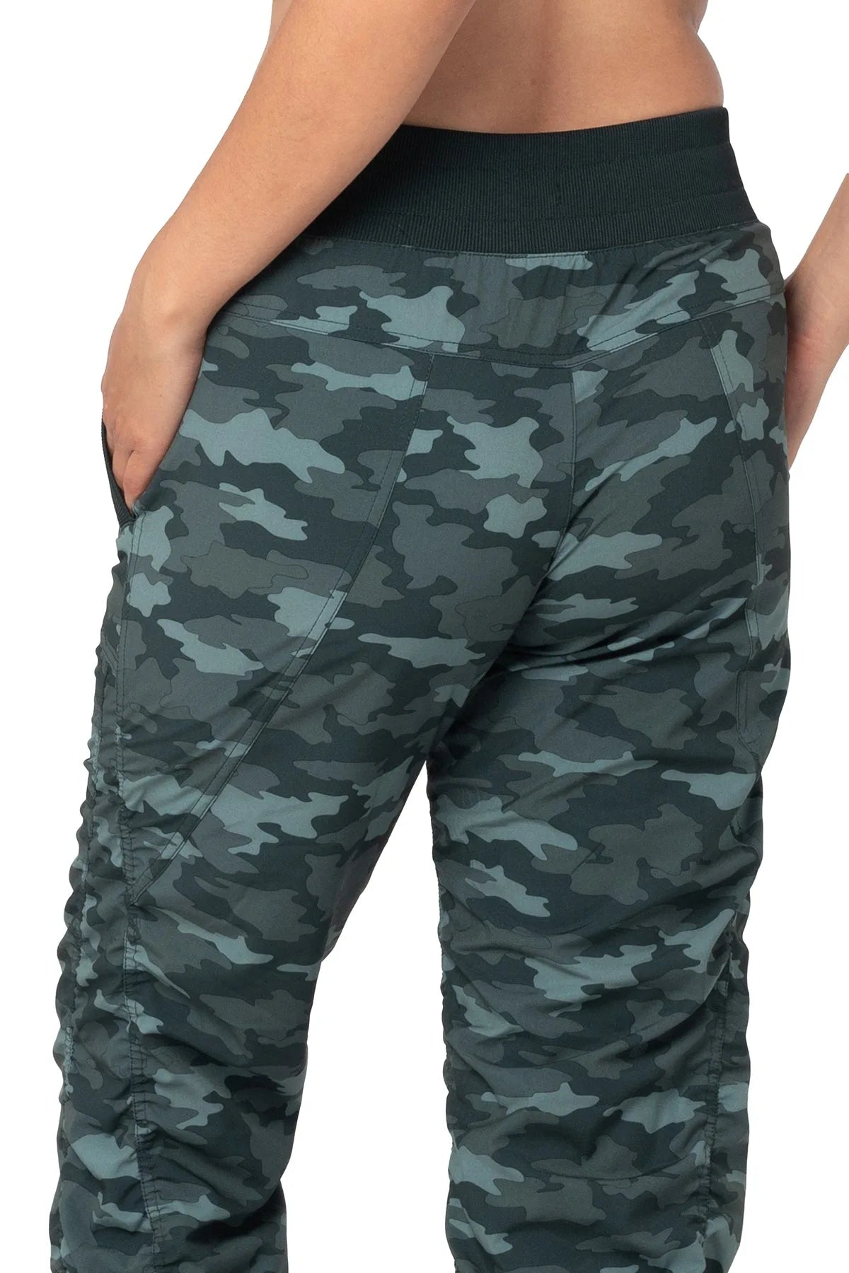 Women’s Black and green camouflage print Adventurous Pant, side studio view showing the patch pocket and tapered gathered hem.