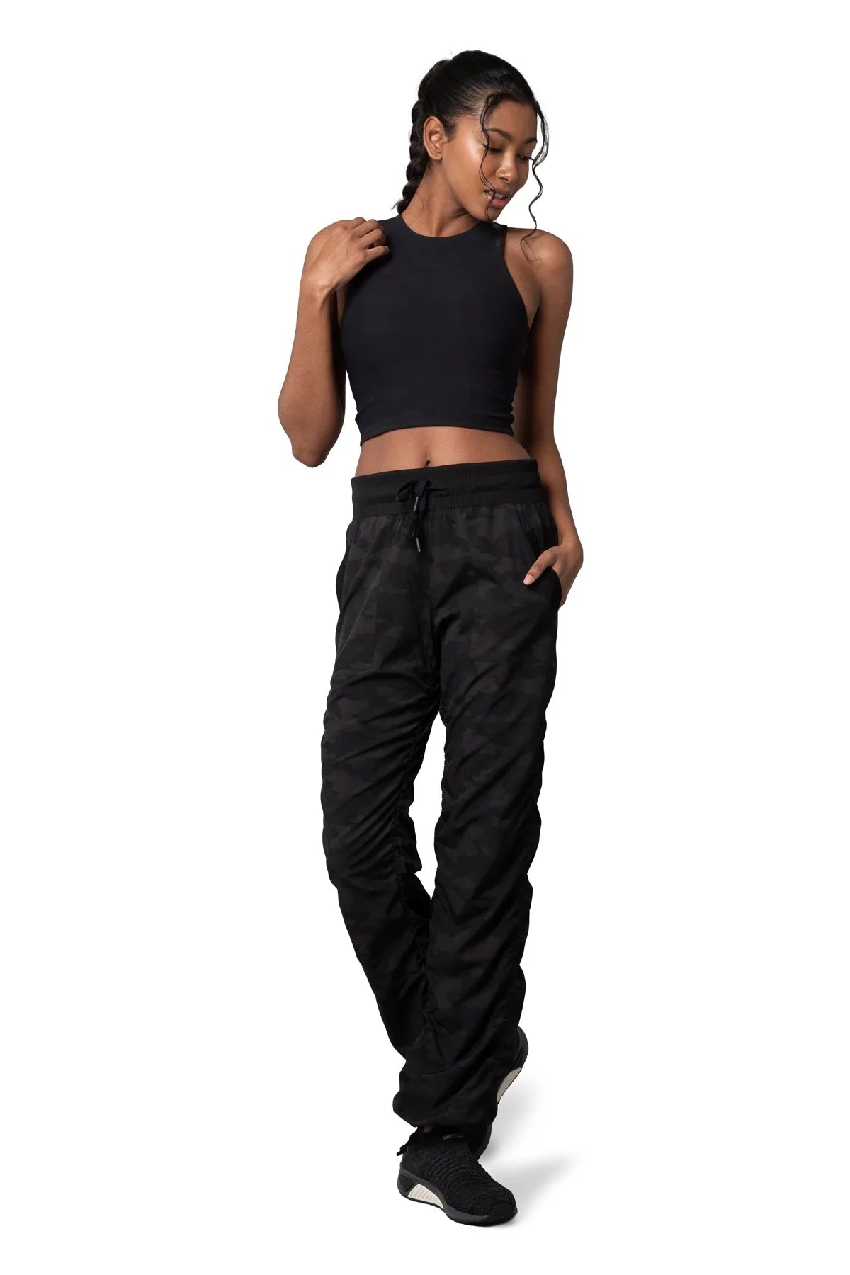 Women’s Dark camouflage print Adventurous Pant, full-body studio pose showing the relaxed silhouette from waist to ankle.
