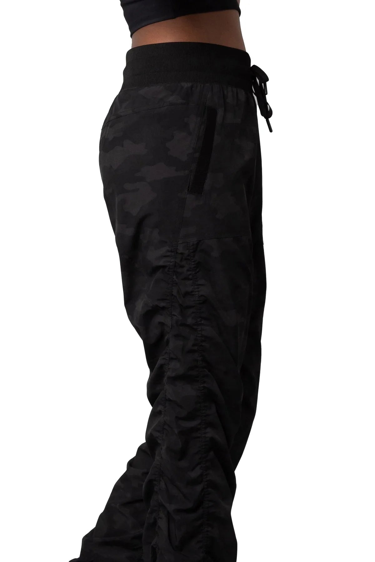 Women’s Dark camouflage print Adventurous Pant, waist and pocket close-up showing the elastic drawstring waistband and utility pocket.