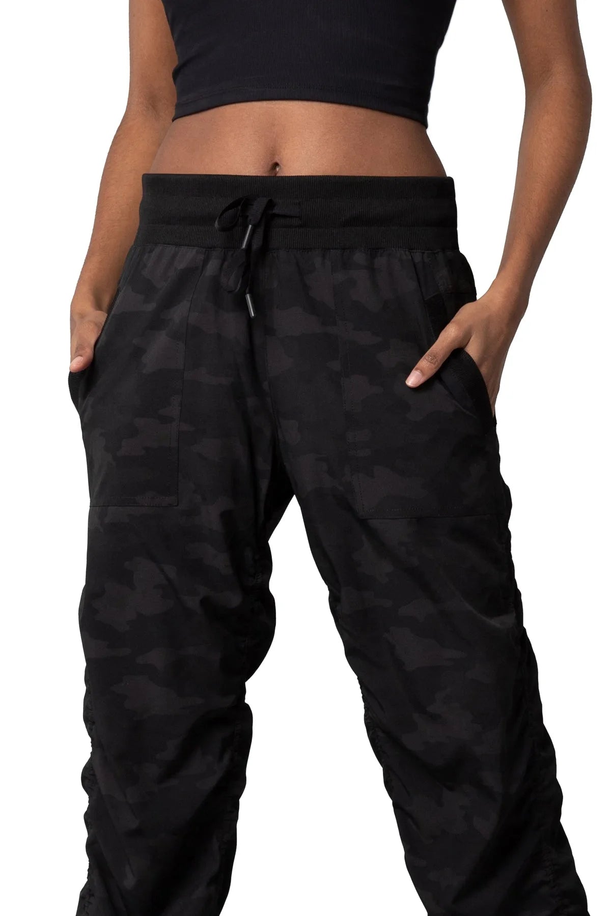 Women’s Dark camouflage print Adventurous Pant, side studio view showing the tapered leg and gathered cuff.