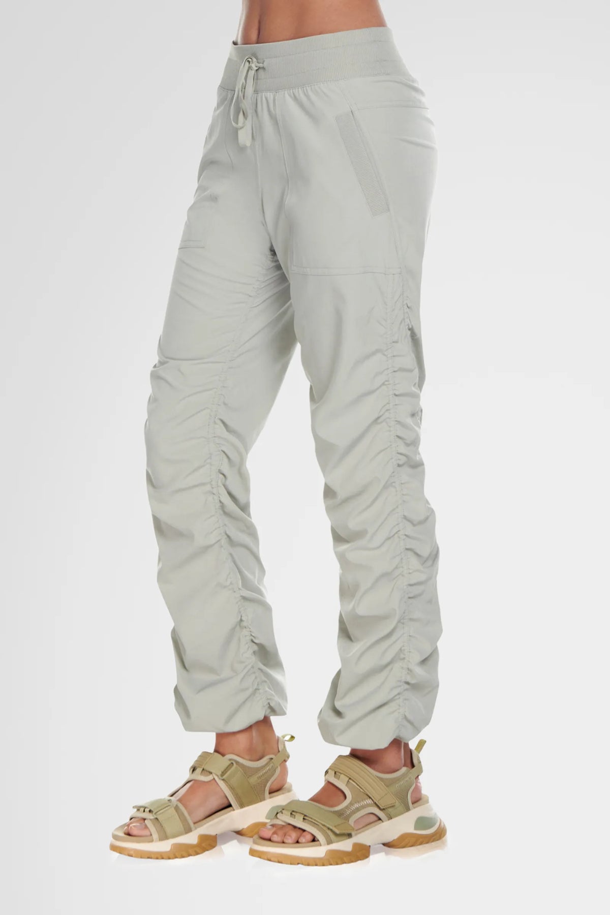 Women’s Cement Adventurous Pant, rear studio view showing the relaxed fit through the seat and gathered cuffs.