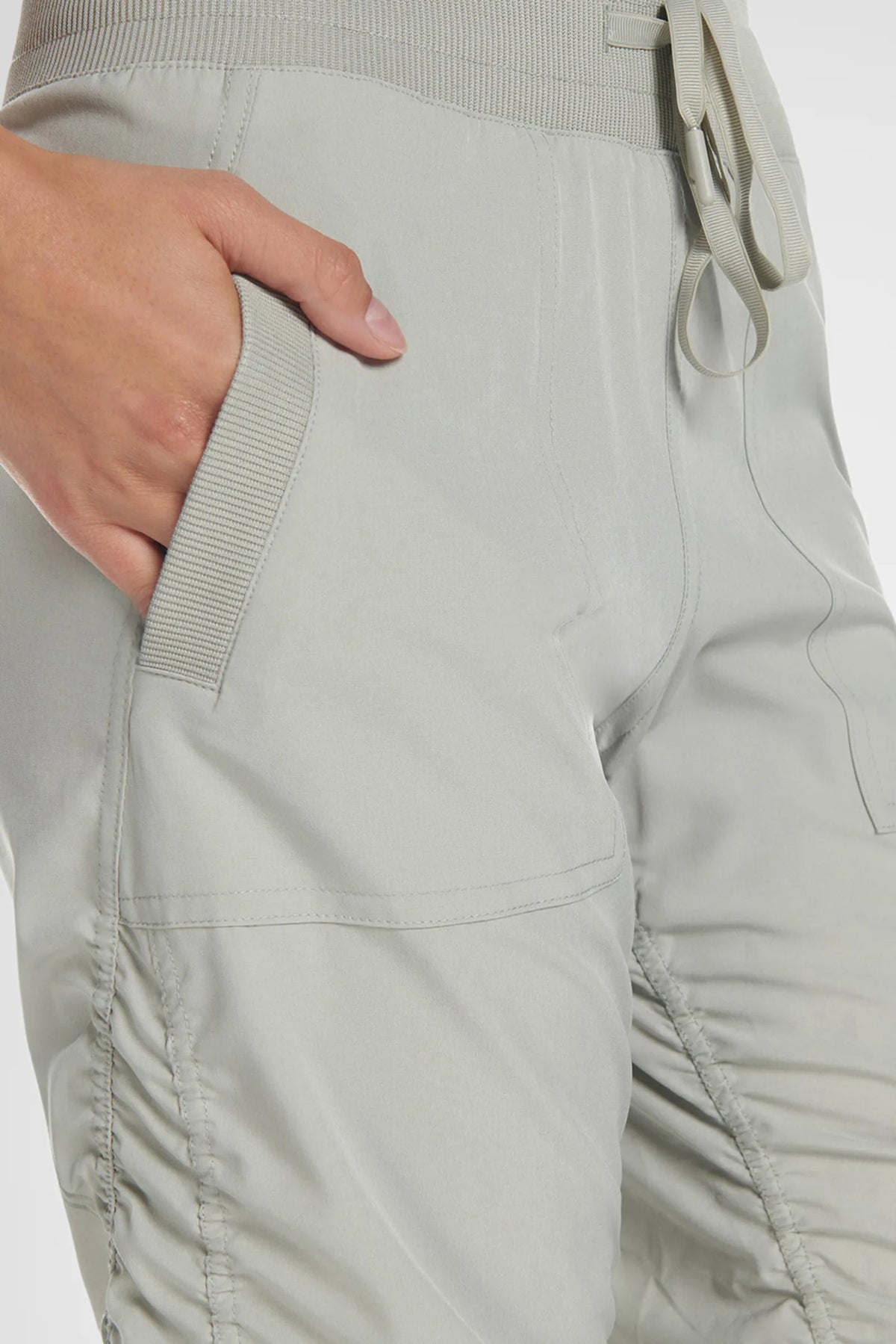 Women’s Cement Adventurous Pant, waist and pocket detail showing the elastic drawstring waistband and utility pocket.
