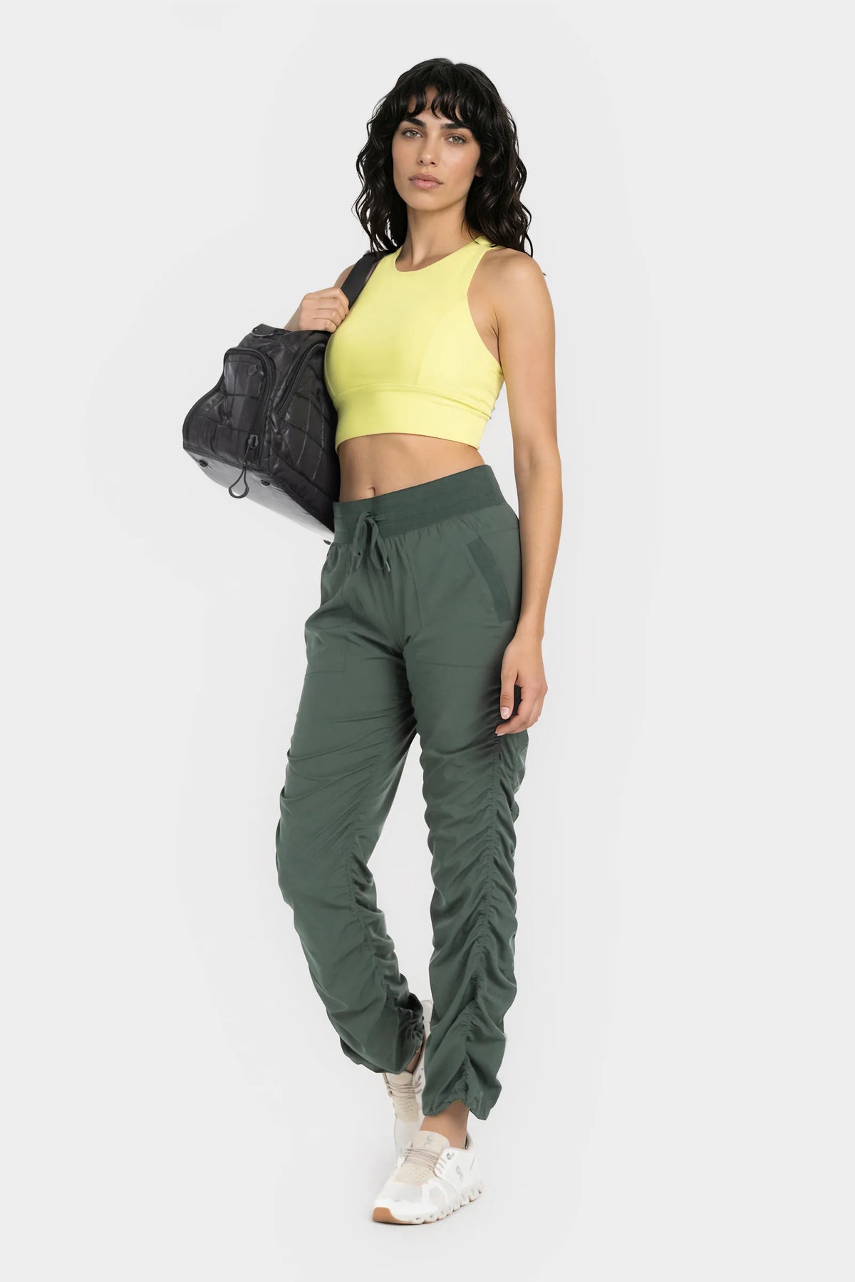 Women’s Cilantro Adventurous Pant, rear three-quarter studio view showing the relaxed fit through the seat and ankle.