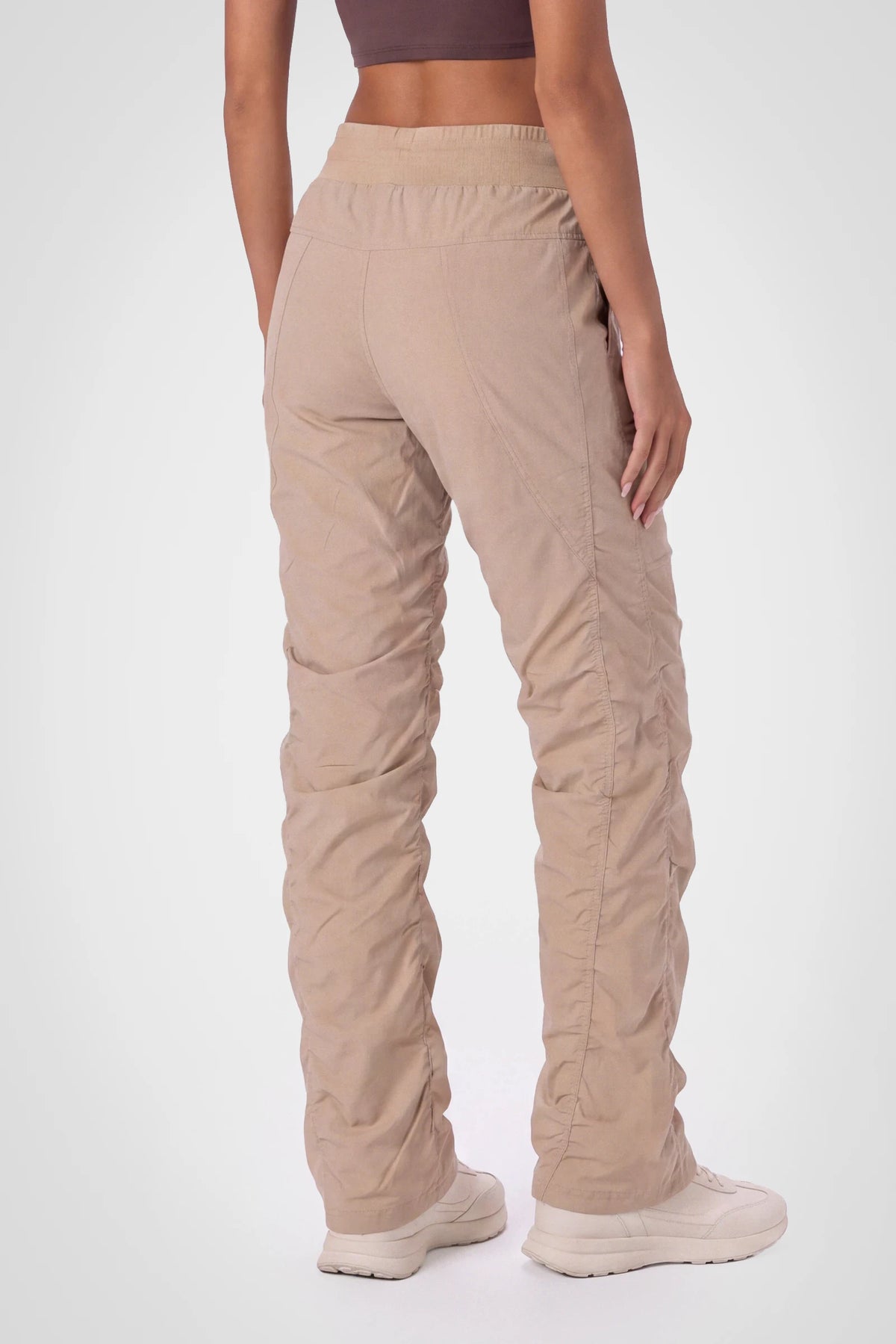 Women’s Doeskin Adventurous Pant, three-quarter studio view showing the tapered leg and gathered hem.