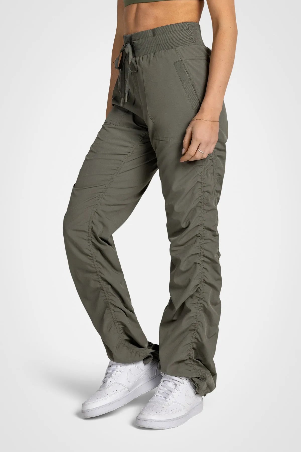 Women’s Dusty Olive Adventurous Pant, front studio view showing the relaxed fit through the leg and gathered cuffs.