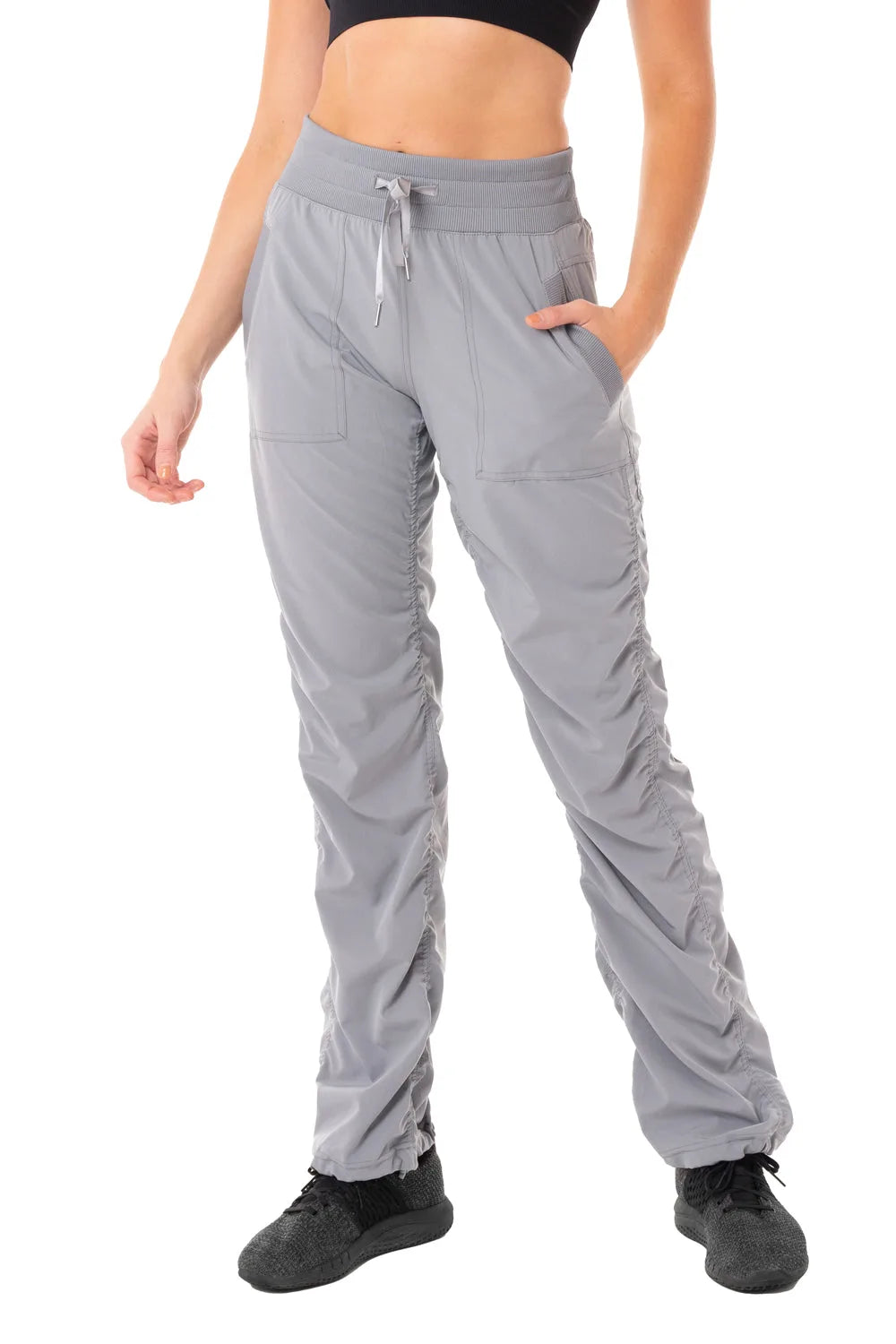 Women’s Grey camouflage print Adventurous Pant, front lower-body studio view showing the elastic drawstring waist, patch pockets and gathered cuffs.