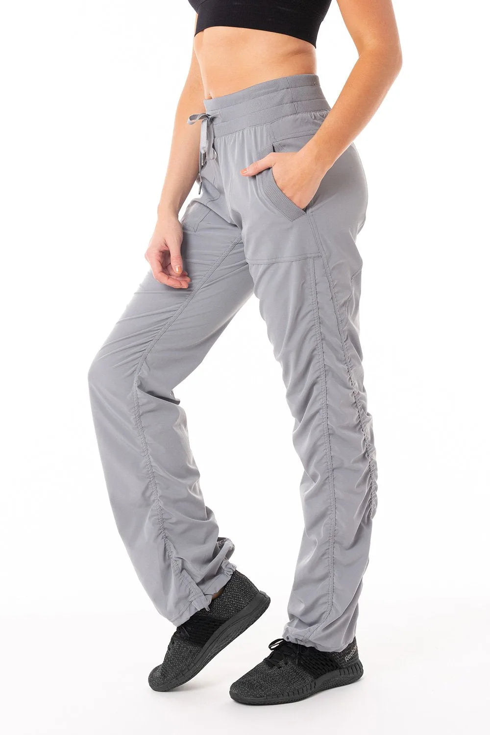 Women’s Grey camouflage print Adventurous Pant, side studio view showing the relaxed tapered leg, utility pocket and gathered cuff.