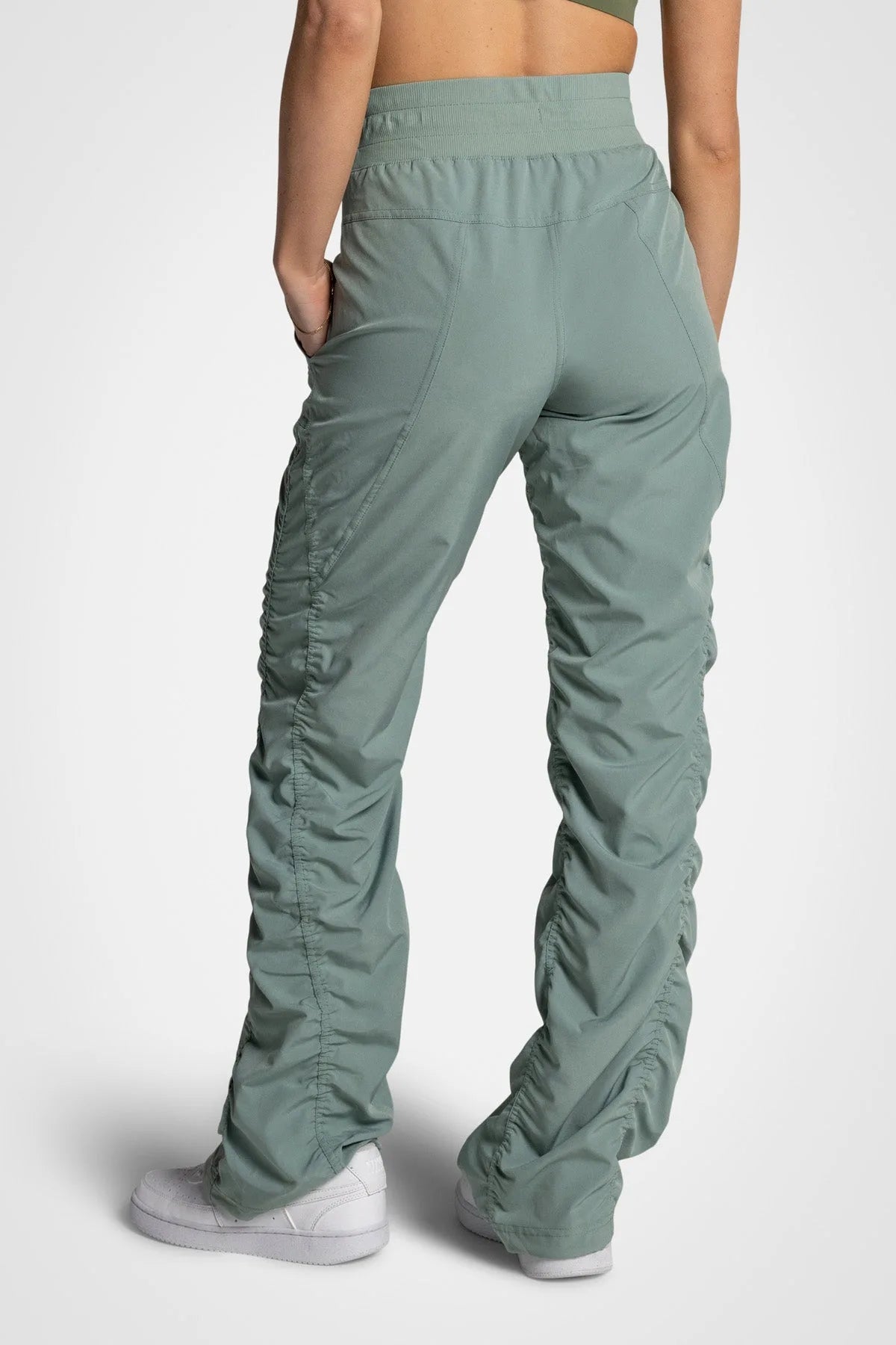 Women’s Iceberg Green Adventurous Pant, rear studio view showing the relaxed fit through the seat and ankle.