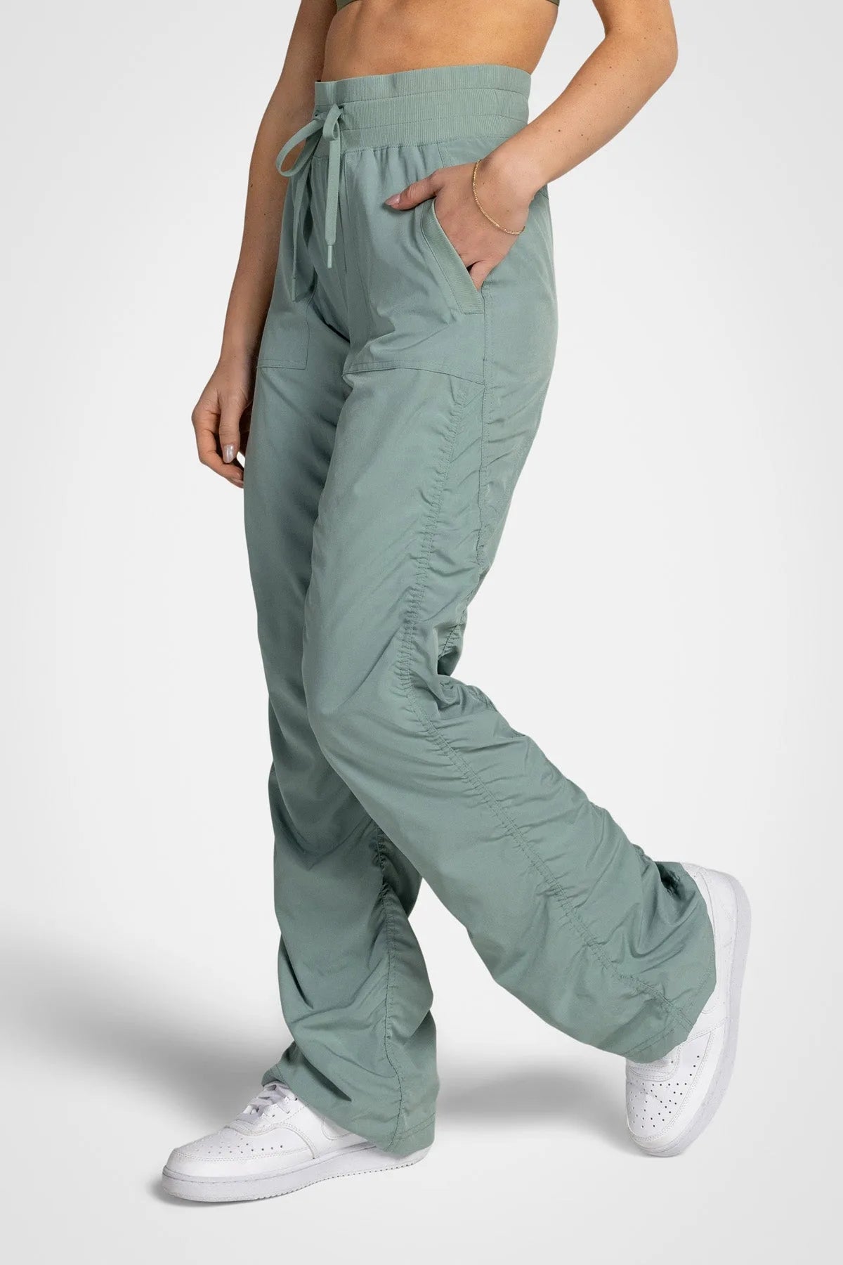 Women’s Iceberg Green Adventurous Pant, waist and pocket close-up showing the elastic drawstring waistband and oversized utility pocket.