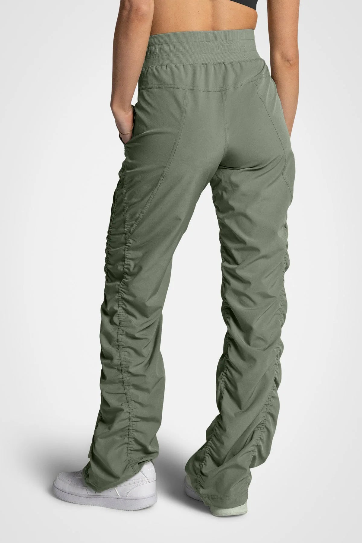 Women’s Laurel Adventurous Pant, side studio view showing the utility patch pocket and tapered gathered hem.
