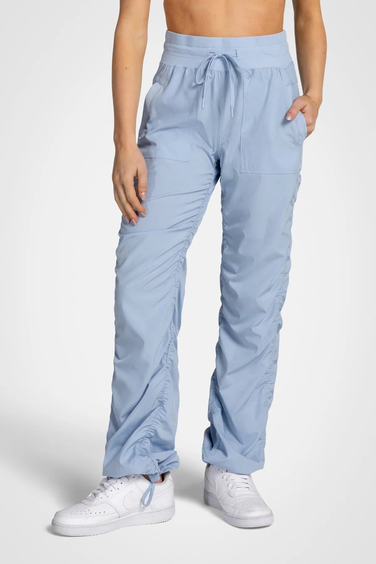 Women’s Skyway Adventurous Pant, side studio view showing the relaxed tapered leg, utility pocket and gathered cuff.