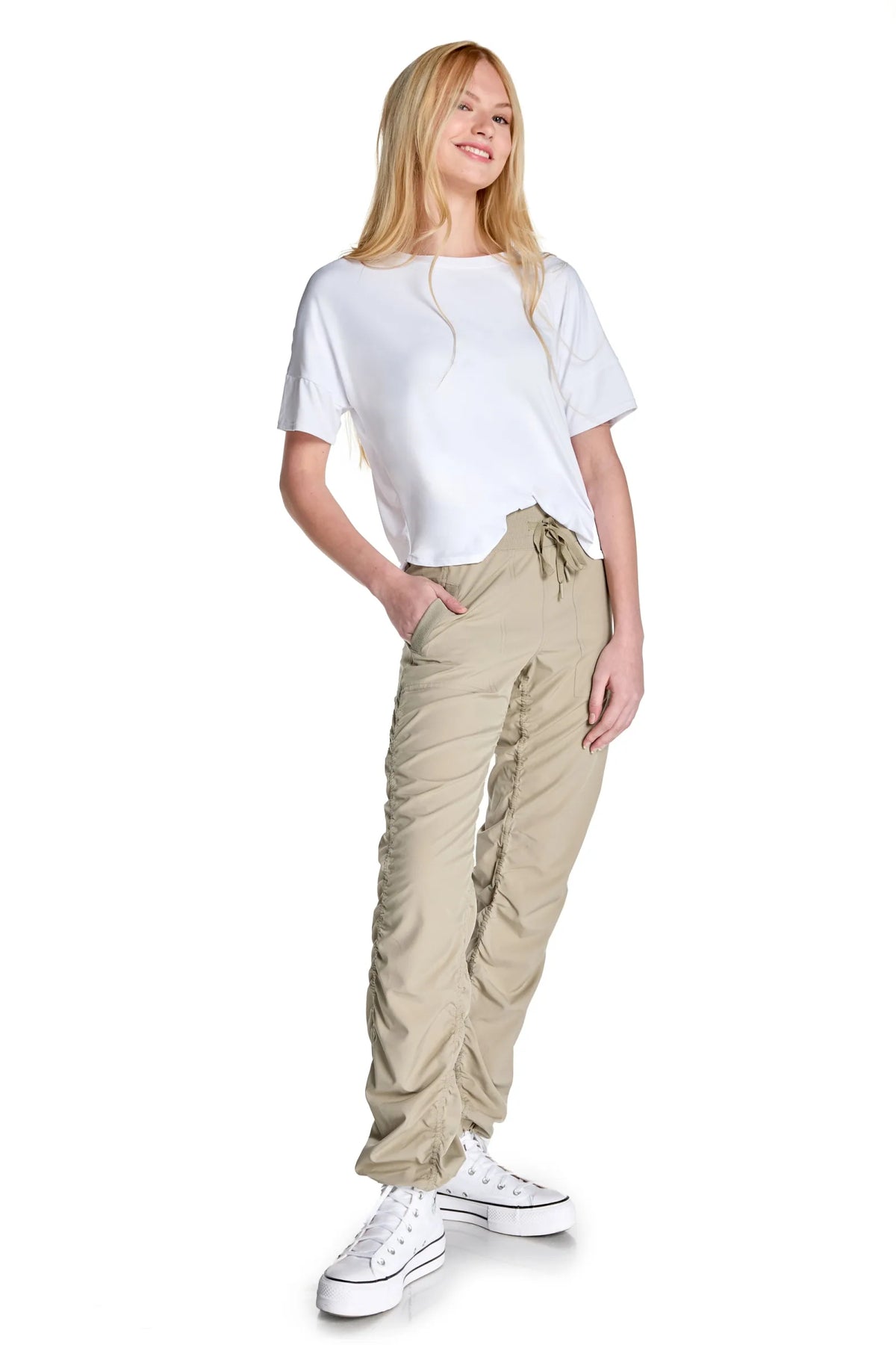 Women’s Warm Taupe Adventurous Pant, rear studio view showing the relaxed fit through the seat and ankle.